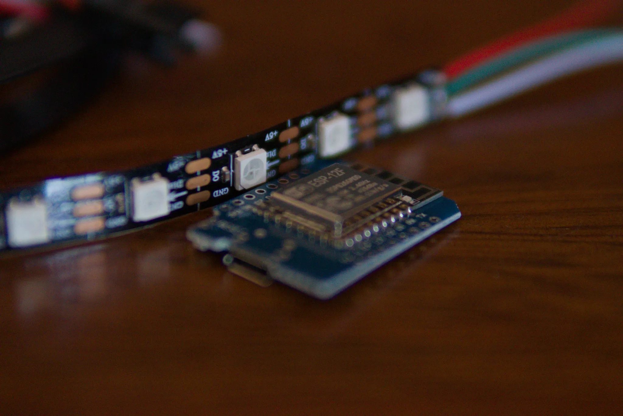 ESP8266 development board beside a WS2812B addressable LED strip.